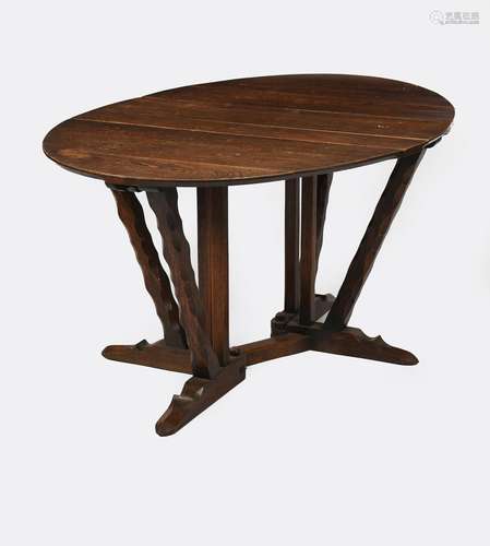 An oak gate-leg table the design attributed to Arthur Romney-Green, elliptical top on carved legs