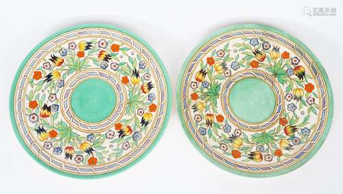 A pair of Bursley Ware wall chargers designed by Charlotte Rhead, pattern TL14, painted with a