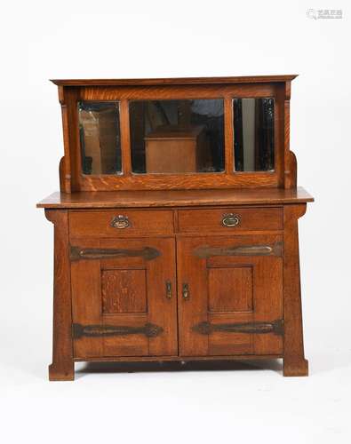 A Liberty and Co style oak buffet sideboard, tapering rectangular section, two drawer base with