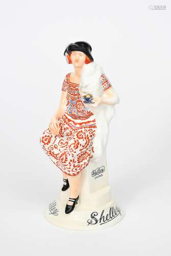 The Shelley Girl a rare Shelley Pottery advertising figure, modelled as a young lady in paisley