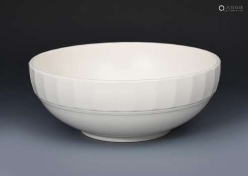 A Wedgwood Moonstone bowl designed by Keith Murray, shallow with faceted rim, covered in a matt