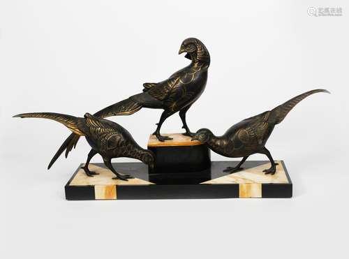 A large patinated spelter sculpture of three exotic birds, on stepped polished onyx and slate