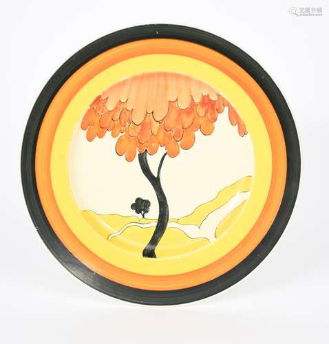 'House and Bridge' a Clarice Cliff plate, painted in colours inside yellow, orange and black