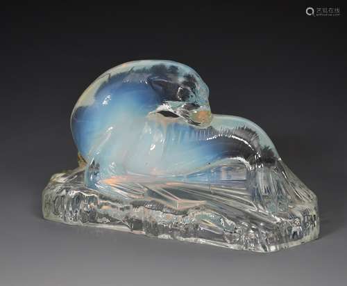 A Joblings Opalique opalescent glass model of a seal, modelled resting on a shaped rectangular