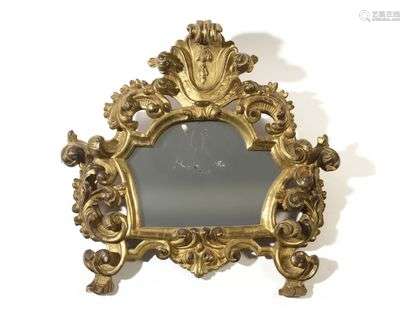Gilded wooden mirror with openwork decoration of foliage and staples, (glass probably replaced).  18th century.  H : 58 cm, W : 60 cm