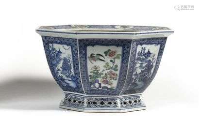 China Octagonal porcelain planter, the openwork base decorated in blue underglaze and enamels of the pink family of landscapes alternating with branches of flowering prunus and birds. Daoguang period (1821-1850), in the Quianlong style Height: 24 cm, Diam: 40 cm (a light hair)