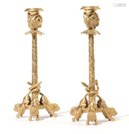 Pair of small gilt bronze candelabra, decorated with ram's heads and foliage, the tripod base with lion figures. Attributed to Christophe Fratin (1801-1864). End of the 19th century H: 23 cm Better known as an animal sculptor, Christophe Fratin also distinguished himself in the field of decorative arts with candelabra and similar torches decorated with monkeys, bears or lions.