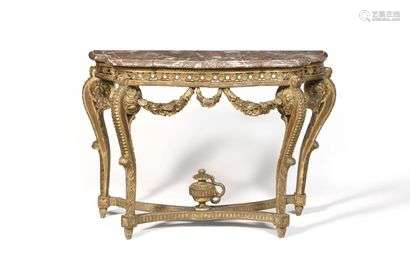 Console table in gilded wood with an animated shape, the belt openworked with interlacing and rosettes, resting on uprights in heart shaped scrolls and garlands joined by a crosspiece surmounted by a vase, top in Royal red marble, (accidents and misses). Louis XVI style. H : 81 cm, W : 115 cm, D : 47,5 cm