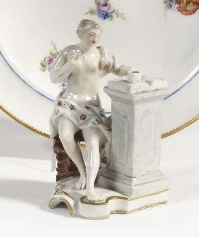 Frankenthal Porcelain statuette representing a woman sitting draped in antique style in front of an open book on a column, polychrome and gold decoration. Marked: NB in hollow and CT crowned in blue. 18th century. H. 11.5 cm.