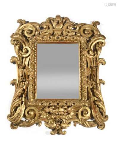 Beautiful rectangular gilded wood mirror with openwork decoration of foliage, scrolls, staples and grotesque mask, (glass replaced). Italy, mid 18th century (restored) H : 107,5 cm, W : 88 cm