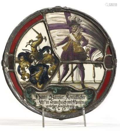 Glass roundel with polychrome painted decoration of a nobleman holding a large banner, coat of arms with helmet with mantling and unicorn crest, inscriptions in Gothic letters and date 1616 on the lower part. Alemannic countries, 17th century, 1616 Diameter: 19.5 cm