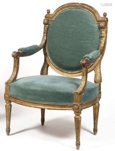 Carved and gilded beechwood armchair, with flat back, oval medallion and consoles, carved with heart shaped grapes, scraps of flowers and foliage, resting on tapered fluted feet, apocryphal stamp of Sené. Louis XVI style (accidents). H : 97 cm, W : 60 cm