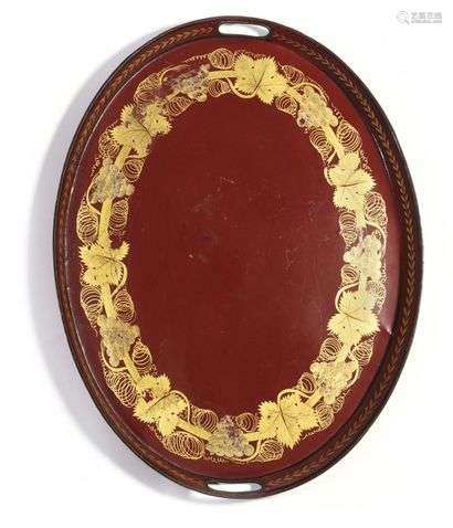 Large oval tray, decorated on a red background with vine branches and a frieze of laurel leaves. Mid 19th century L : 61,5 cm (light wear).