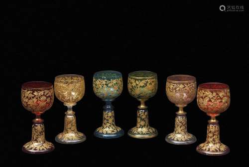 Group of six facon de venise wine glasses of various colours, all with a trailing floral gilt design