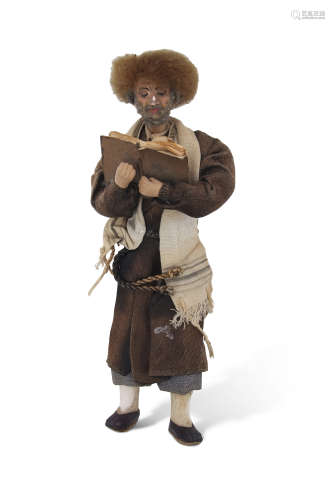 Middle Eastern or Afghan doll modelled as a man wearing prayer shawl reading the Koran, 20cm long