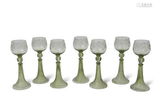 Group of seven Bohemian wine glasses, the bowls engraved with a fruiting vine design above a stem