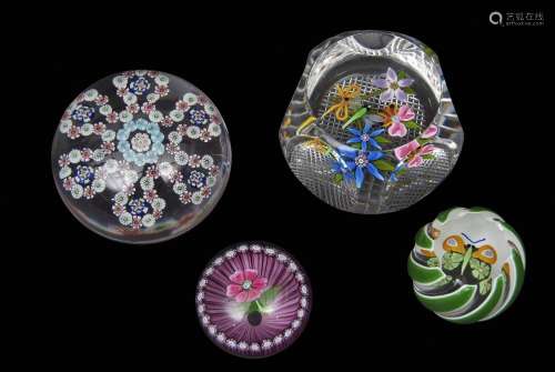 Group of paperweights including three Perthshire weights with multi-coloured designs and a