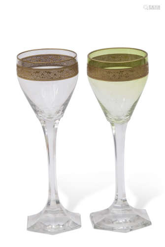 Pair of Continental wine glasses, one stained green, both glasses with a gilt foliate band to