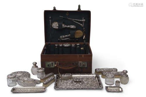 Edwardian leather travelling case with a majority of the original fittings including five silver