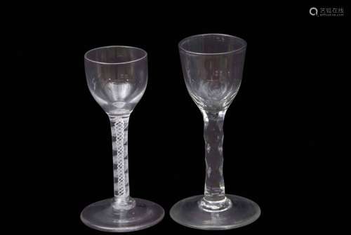 Two 18th century wine glasses one with bucket shaped bowl above a faceted stem, the other ogee