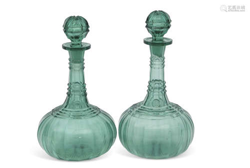 Two 19th century cut glass decanters stained green with star cut bases, 28cm high (2)