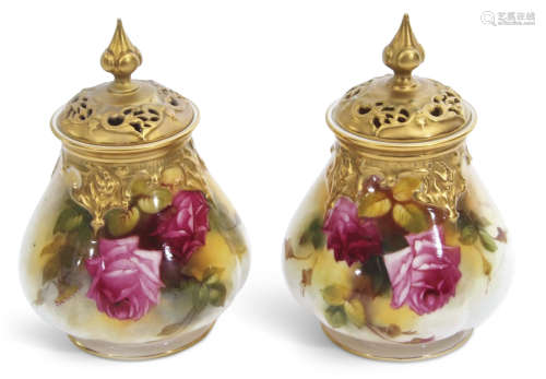 Pair of Royal Worcester pot pourri vases with gilt reticulated covers, painted with roses, one