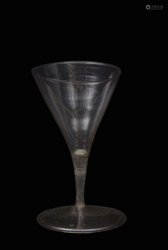 Mid-17th century facon de Venise soda glass, the trumpet bowl over short slender hollow stem with