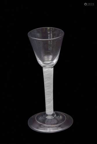 Mid-18th century wine glass, the rounded funnel bowl above a multi-spiral opaque twist stem and
