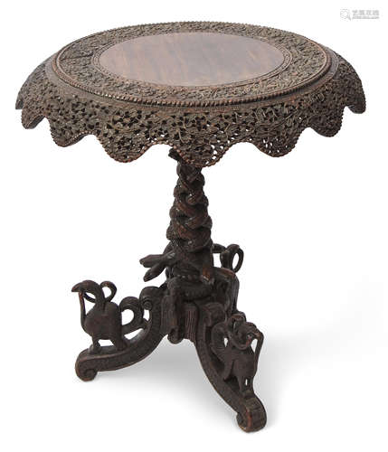 Anglo-Indian hardwood pedestal table, circular top with a swept shaped frieze raised on central