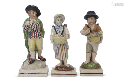 Group of three early 19th century pearlware figures, one of a skater on a rectangular base, two