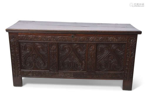 18th century large proportion oak coffer with a carved three panel front with floral and scrolling