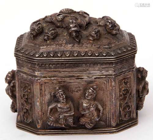 19th century Indian white metal lidded box of sarcophagus form, the sides and lid heavily embossed