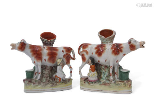 Pair of Staffordshire milking groups, both decorated in typical fashion with milkmaids and the