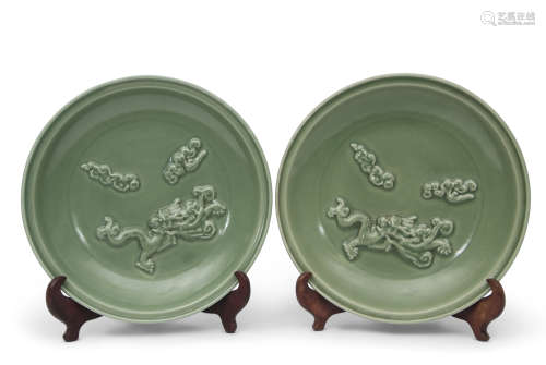 Two Longquan celadon chargers, both decorated in relief with dragons chasing the flaming pearl, 37cm