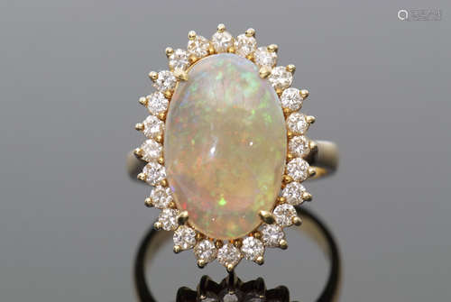 Opal and diamond dress ring, the oval shaped cabochon opal raised within a small diamond surround,