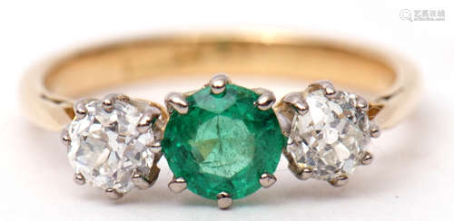 Emerald and diamond three-stone ring, the centre a circular shaped faceted emerald between two old