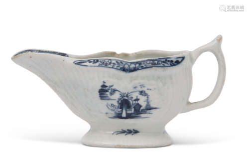 Small Lowestoft porcelain sauce boat, the reeded body with two panels decorated in underglaze blue