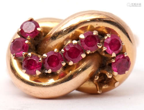 Stylised ruby set dress ring, an entwined plain polished tubular design set with eight small