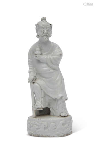 Chinese porcelain white glazed figure of an immortal, probably Li Teaquai, in typical pose, the