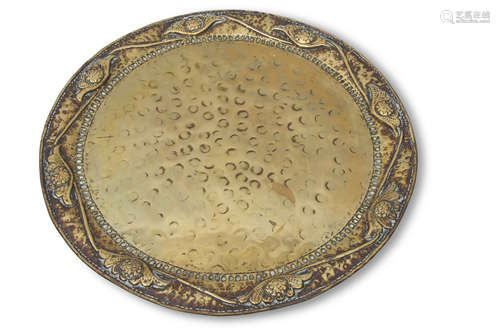 Early 20th century Arts & Crafts circular brass tray, having foliate and scrolled edge, spot