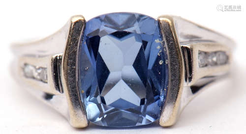 Precious metal sapphire and diamond ring, the centre barrel shaped sapphire raised between diamond