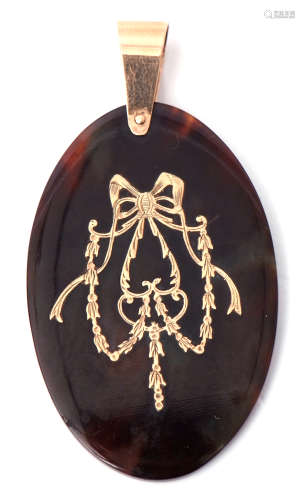 Victorian tortoiseshell pique pendant, oval shaped and inlaid with a golden bow and garland