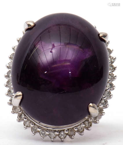 Large amethyst and diamond dress ring, the large oval shaped cabochon 24mm x 24mm, four claw set and