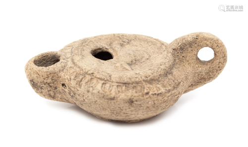 A Roman Style Terracotta Oil Lamp Length 3 1/2 inches.