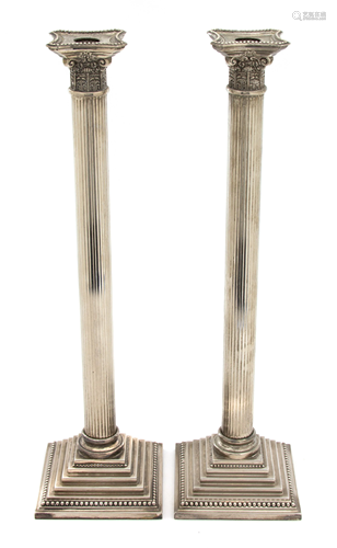 A Pair of Silver Plate Tall Columnar Candlesticks