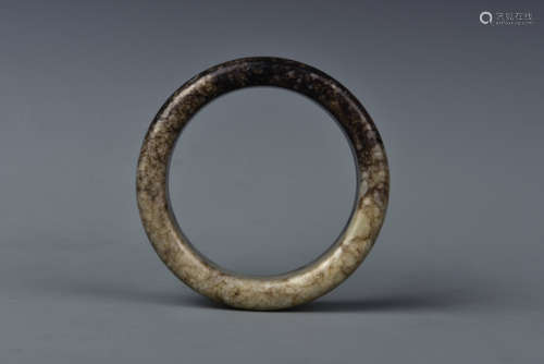 A CREAMY WHITE AND RUSSET JADE BANGLE MING DYNASTY