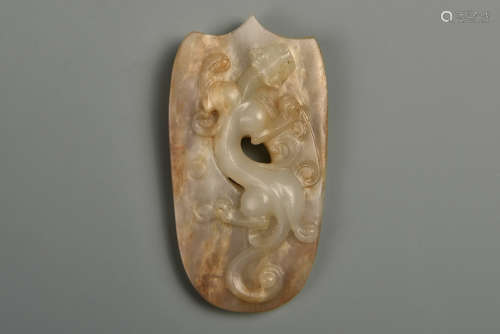 A CARVED WHITE AND RUSSET ORNAMENT HAN DYNASTY