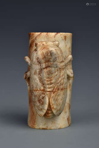 A CREAMY WHITE AND RUSSET JADE ARMREST MING DYNASTY OR LATER