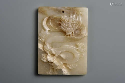 A CARVED CREAMY WHITE JADE PLAQUE