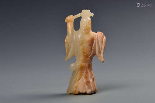A CARVED WHITE AND RUSSET JADE STANDING FIGURE MING DYNASTY